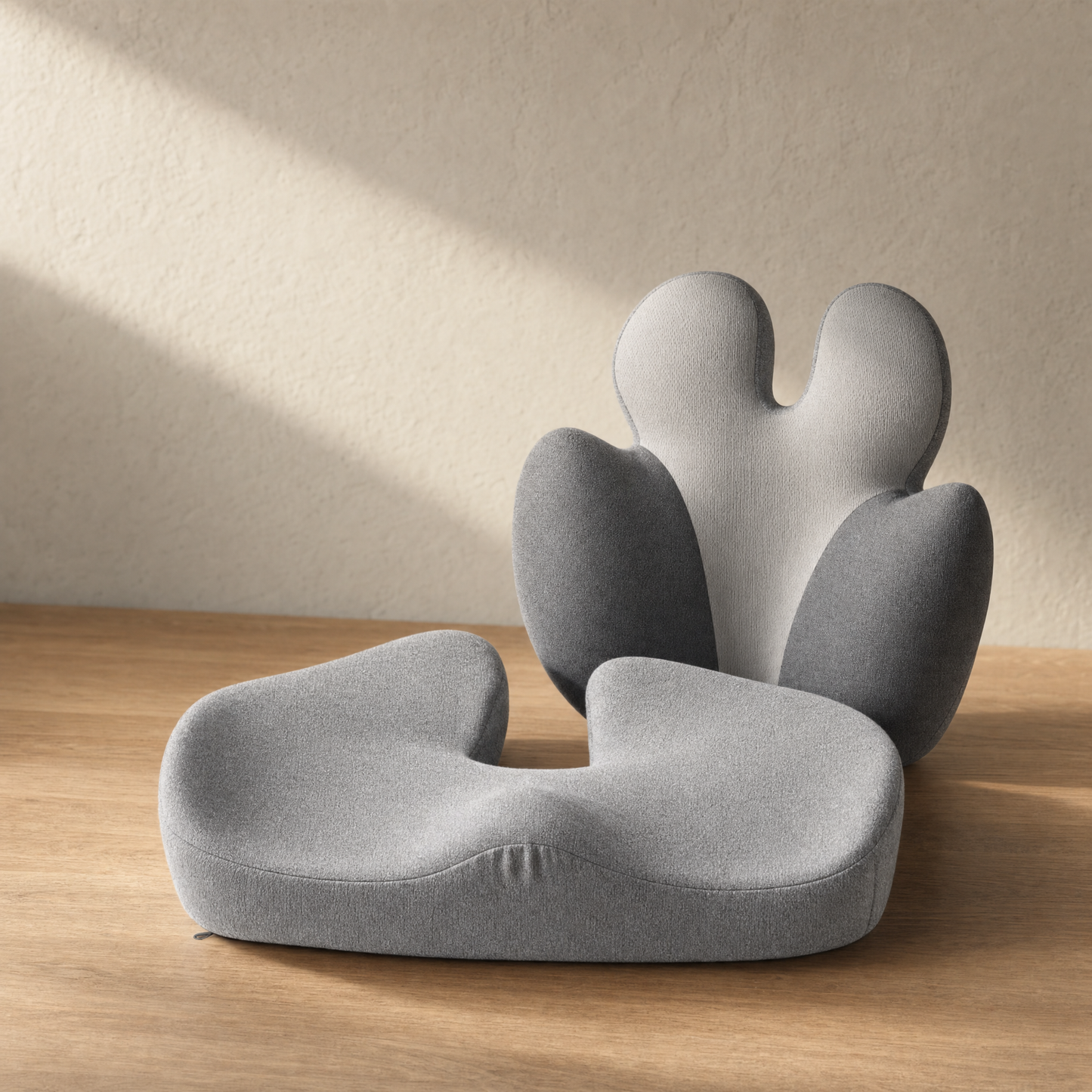 VESU Orthopedic Seat and Lumbar Cushion Set arranged on warm oak in soft light