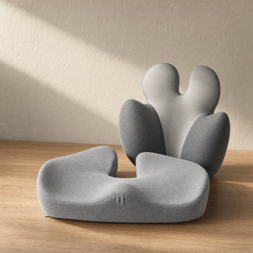 VESU Orthopedic Seat and Lumbar Cushion Set arranged on warm oak in soft light